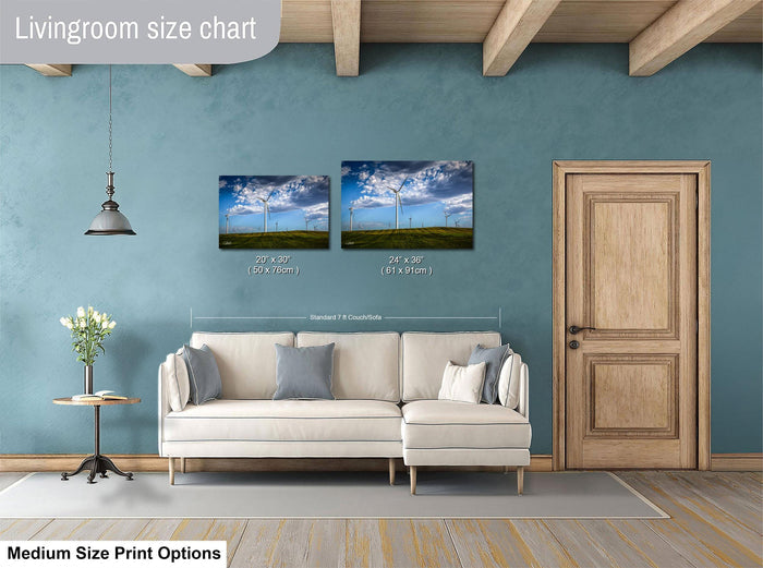 a living room with a white sofa, a wooden door, and a painting of a wind farm on the wall. The living room appears to be well-lit and spacious, with a wooden ceiling and a hanging light fixture.