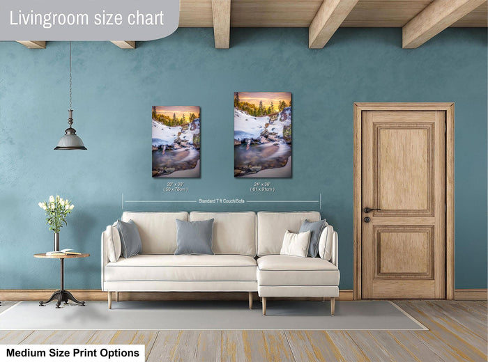 a living room with a white sofa, a wooden door, and a painting of a snowy landscape on the wall.