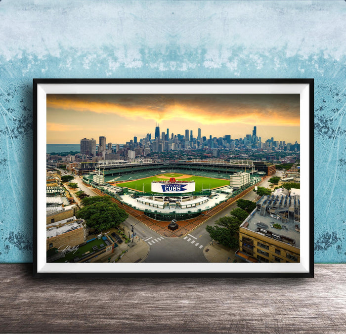 The image is a framed photograph of a baseball stadium in Chicago, Illinois, with the city skyline in the background.