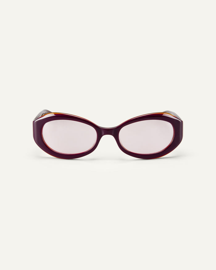 Face shot of Bonnie Clyde XOXOx2 sunglasses in dark pink with pink lenses.