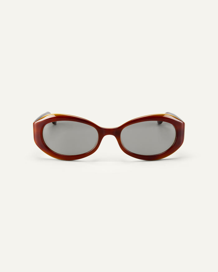 Face shot of Bonnie Clyde XOXOx2 sunglasses in tortoise with grey lenses.