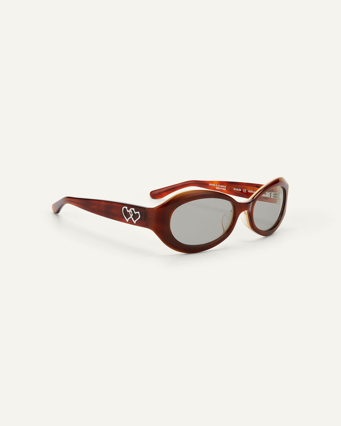 Quarter shot of Bonnie Clyde XOXOx2 sunglasses in tortoise with grey lenses.