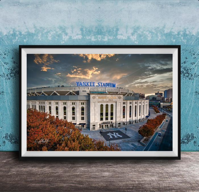 A framed photograph of Yankee Stadium, a baseball stadium located in New York City, with the stadium's name prominently displayed on the exterior.