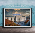 A framed photograph of Yankee Stadium, a baseball stadium located in New York City, with the stadium's name prominently displayed on the exterior.
