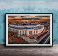 The image is a framed photograph of the Yankee Stadium in New York City, with a stunning sunset in the background.