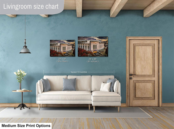 a living room with a white sofa, a wooden door, and a painting of a building on the wall. The painting is of a standard size of 24x36 inches.