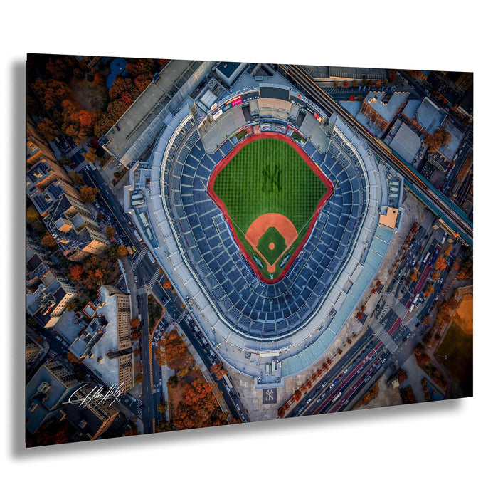 An aerial view of a baseball stadium with a green field and red lines marking the seating areas.