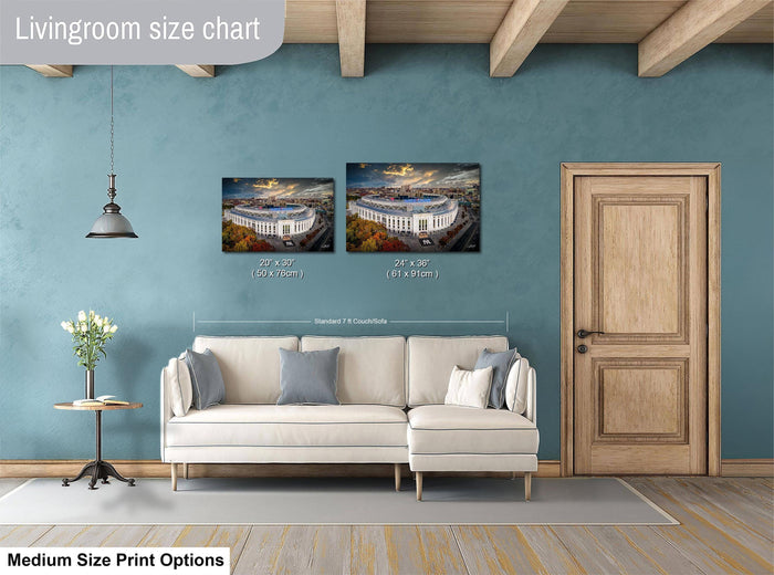 a living room with a white sofa, a wooden door, and a painting of a stadium on the wall. The painting is of a large stadium with a blue sky and clouds in the background. The sofa is positioned in front of the painting, and there is a lamp hanging from the ceiling. The wall has a blue color, and the floor is covered with a rug.