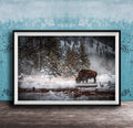 A large framed photograph depicting a bison grazing in a snowy forest landscape.