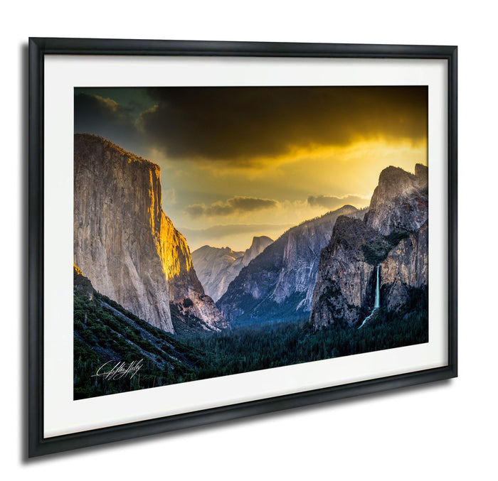 a breathtaking view of a mountainous landscape at sunset, with towering cliffs and a waterfall cascading down the side.