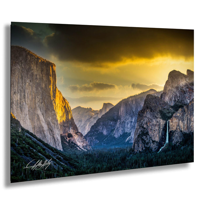 a breathtaking view of a mountainous landscape at sunset, with towering cliffs and a cascading waterfall.