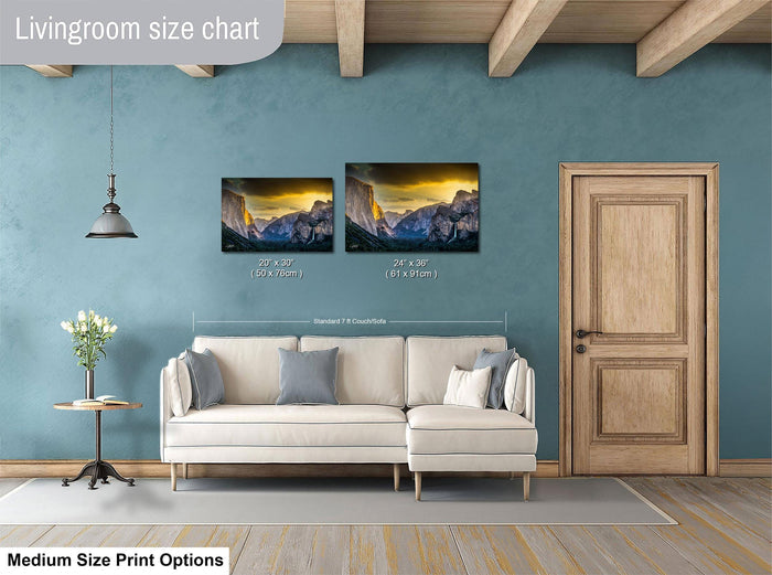 a living room with a white sofa and a wooden door. Above the sofa, there is a livingroom size chart that provides the dimensions of two framed landscape paintings hanging on the wall.