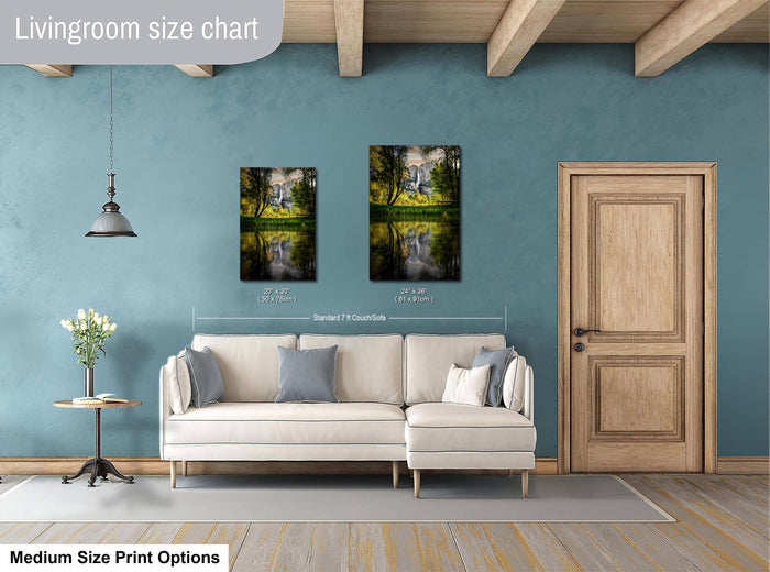 a living room with a white sofa, a wooden door, and a painting of a landscape on the wall.