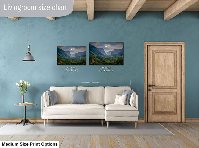 a living room with a white sofa, a wooden door, and a painting of a mountain landscape on the wall.