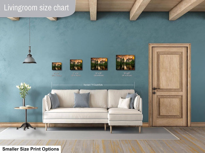 The image is a living room with a white sofa and a wooden door. There are four framed landscape paintings of varying sizes displayed on the wall above the sofa.